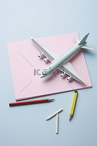 道具箱ui背景图片_飞机道具站在纸和铅笔旁边