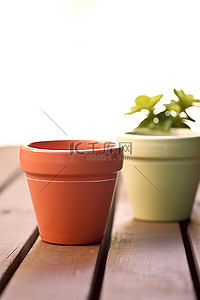粘土花背景图片_木桌上排列着两个不同颜色的粘土花盆
