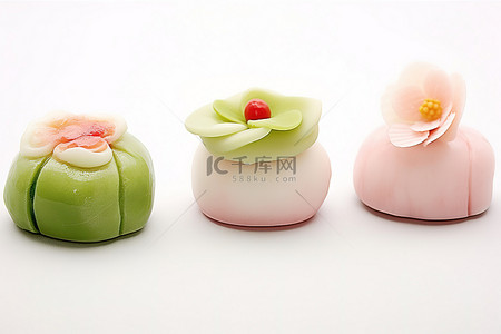 四个小水果形状的甜点坐在白色的表面上