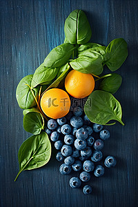 水果蓝水果背景图片_蓝色表面上的蓝莓和菠菜