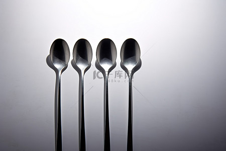 四把勺子和一些银器坐成一排