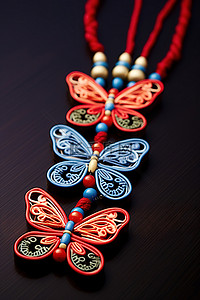 国潮吊饰背景图片_饰有两只蝴蝶的装饰性吊坠项链