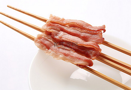 筷子夹着生熟的亚洲培根