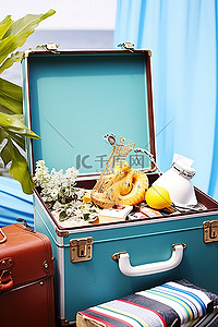 桌子旁边一个球背景图片_一个手提箱，里面有各种各样的东西，旁边坐着一张蓝色的桌子和一个