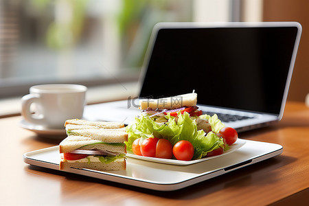 咖啡三明治背景图片_桌上放着三明治的笔记本电脑
