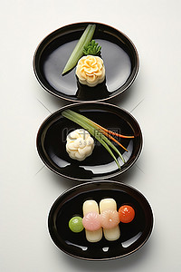 爽口小菜背景图片_黑盘上有四个小菜和蔬菜