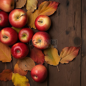 感恩背景图片_苹果和秋天的树叶在木背景上