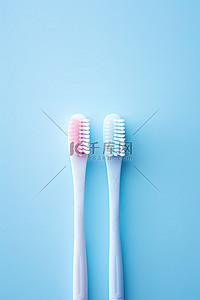 牙刷背景背景图片_蓝色背景中带有蓝色手柄的两支牙刷