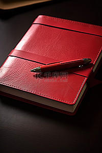 卡片红色背景图片_一本带有子弹日记和记号笔的红色皮革书