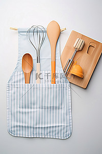 围裙背景图片_木桌上围裙里的烹饪工具