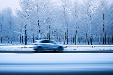 小汽车背景图片_一辆小汽车在雪路上驶过几棵树