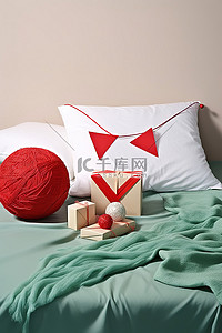 一张床旁边有一个红色毛线球和一些礼品卡