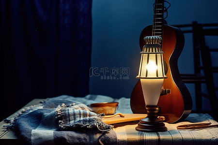 尤克里里背景图片_蓝色布和乐器旁边的一盏灯和一个灯笼