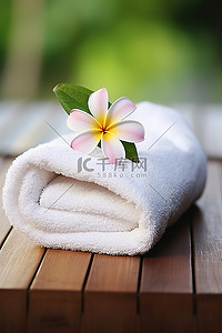 毛巾花背景图片_木板上的温泉毛巾与花