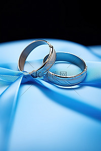 蓝绳背景图片_蓝丝带上的一对结婚戒指