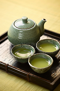 黑茶壶背景图片_黑托盘上的绿茶壶和杯子