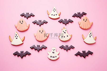 一摞饼干背景图片_饼干鬼和蝙蝠显示在粉红色的背景上