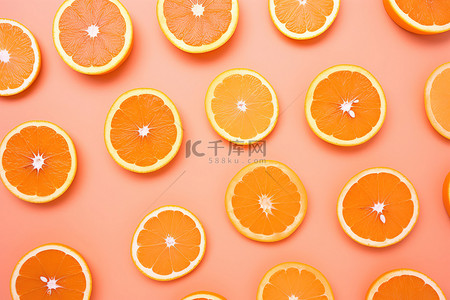 橙子脆片棉花背景图片_粉红色背景上的几片橙子