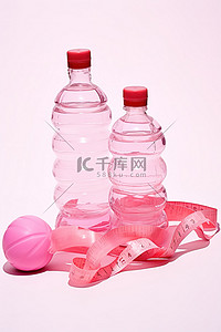 一瓶水背景图片_2 个粉色砝码和一瓶水