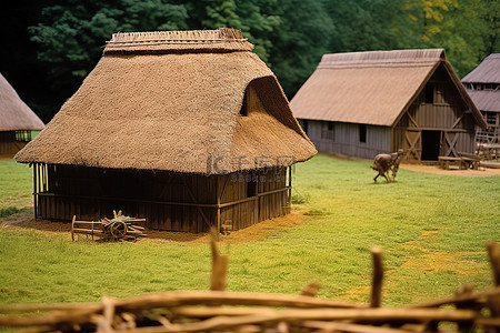 海外仓背景图片_田野里有两三个茅草屋顶的谷仓