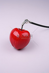 一个红苹果附在白色塑料听诊器上