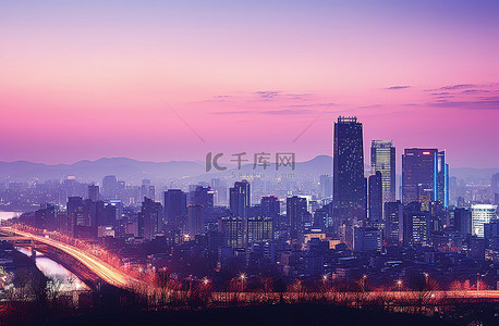 吉隆双子塔背景图片_首尔的天际线在日落时照亮