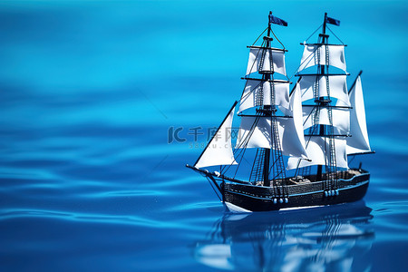 船帆背景图片_一艘船帆漂浮在水面上的玩具船 照片