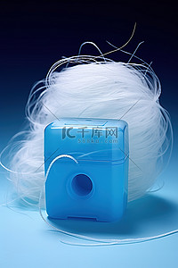 头脑线团背景图片_一个电动纸巾盒旁边放着一团白色的线