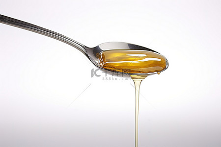 蜂蜜背景图片_白色背景上的一勺蜂蜜