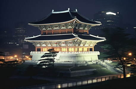 夜晚城市背景图片_首尔最具标志性的宝塔在夜间亮起灯光