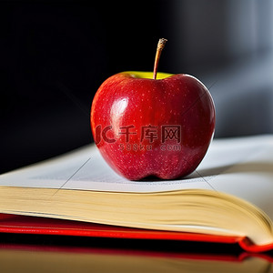 书本上背景图片_上学日把苹果放在书本上