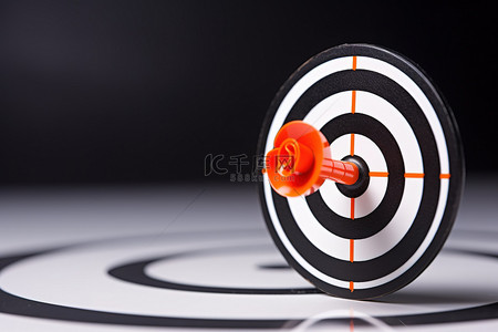 箭头图片可爱背景图片_瞄准黑白目标上目标的橙色箭头