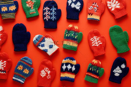 冬天红色背景背景图片_红色背景中的许多针织手套