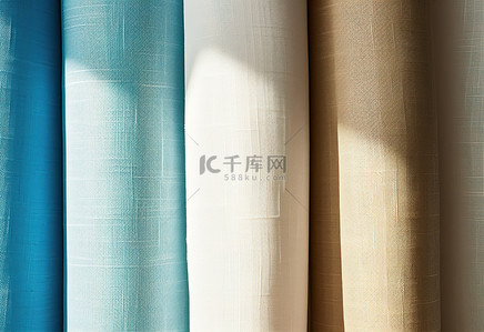 亚麻织物背景图片_墙上有四种颜色的亚麻织物，蓝色