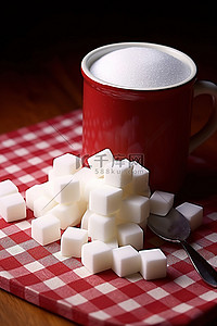 立方体容器背景图片_红白格子桌上放着一杯糖和立方体