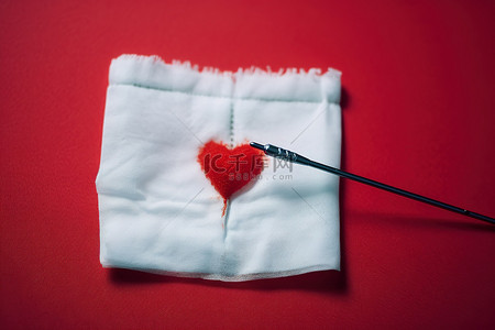 血液背景图片_纸巾上有一颗红心的针