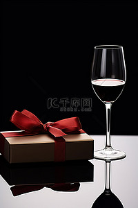 酒礼盒背景图片_巧克力礼盒，配有一杯酒和红色蝴蝶结