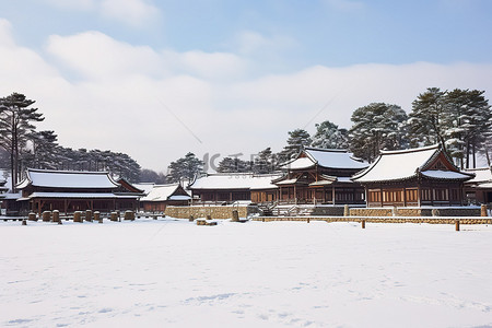 冬天古建筑背景图片_田野前的积雪覆盖的木制建筑