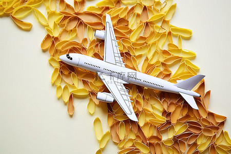 彩色飞机背景图片_黄色叶子上的彩色飞机