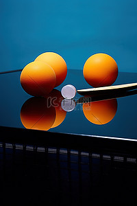 蓝桌上的两个橙色乒乓蛋
