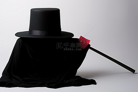 剪纸帽子花背景图片_带卡片和围巾的黑帽子