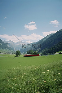 一片绿色的草地和山脉，山谷一侧有一列红色火车