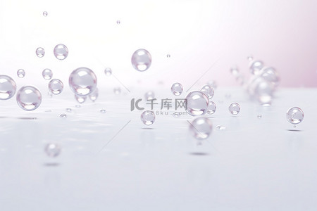 珍珠粒子背景图片_一些水滴落在白色表面上