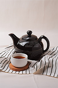 条纹桌布背景图片_条纹桌布上的黑色茶壶