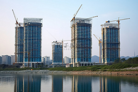 建设升级背景图片_位于正在建设的湖边的高层塔楼