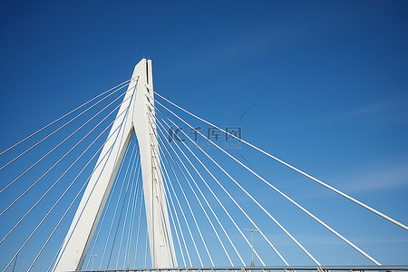 蓝天上有电线和金属棒的桥