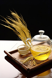茶叶背景图片_木板上的年轻小麦，配有茶杯和茶叶