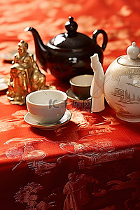 中国红布背景图片_红布上的金银茶壶和雕像