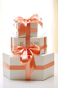 情人节橙色背景图片_三个堆叠的盒子是白色和橙色的，周围有丝带