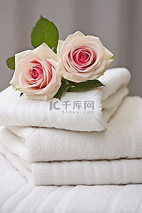 两朵玫瑰上放一叠毛巾